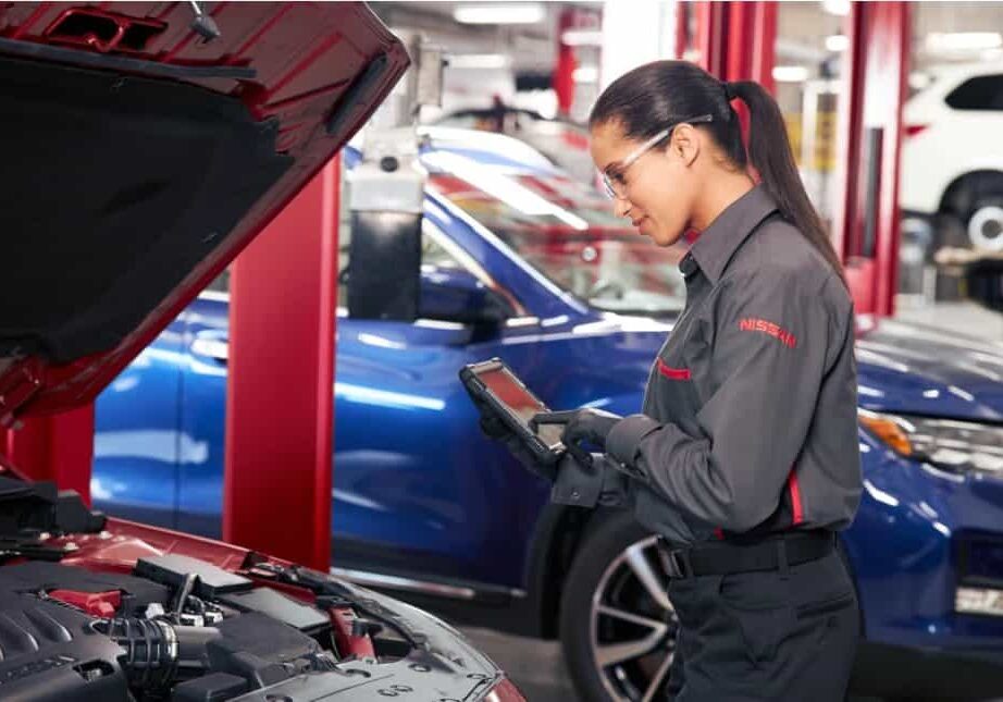 female-nisssan-mechanic-looking-at-vehicle-computer-monitor